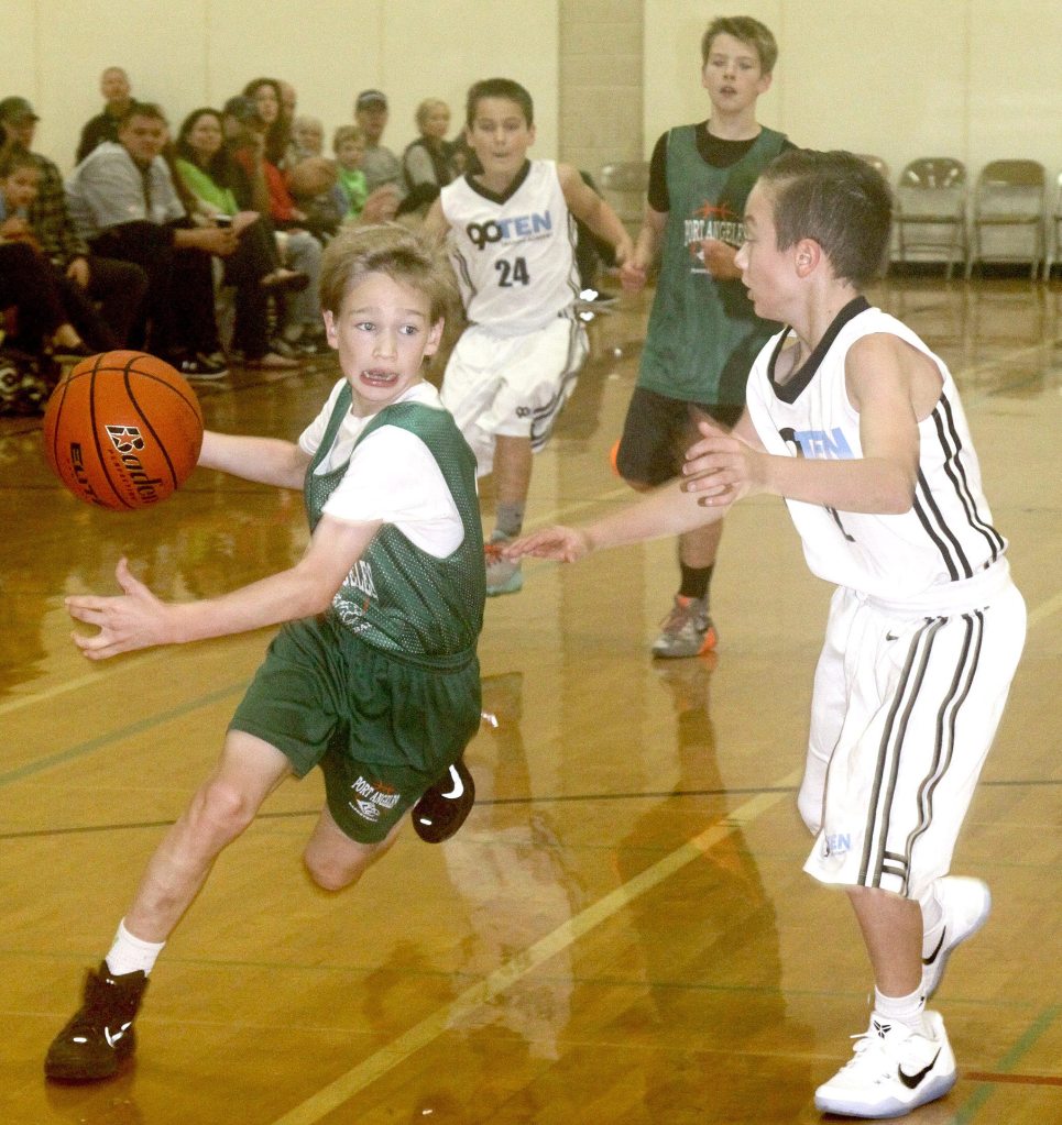 David Logan/For the Peninsula Daily News                                The two day Tip-Off Basketball Tourney was held this weekend at the PAHS gym and Roosevelt gym. Twenty-six girls and boys&rsquo; teams in grades 6th through 8th participated with teams coming from as far as Marysville and Tumwater. Port Angeles Park and Rec sponsored the tournament. Josiah Long of the 6th-grade Port Angeles team drives around a Tumwater opponent. The Port Angeles team went on to win the game 28-19 on Sunday morning.