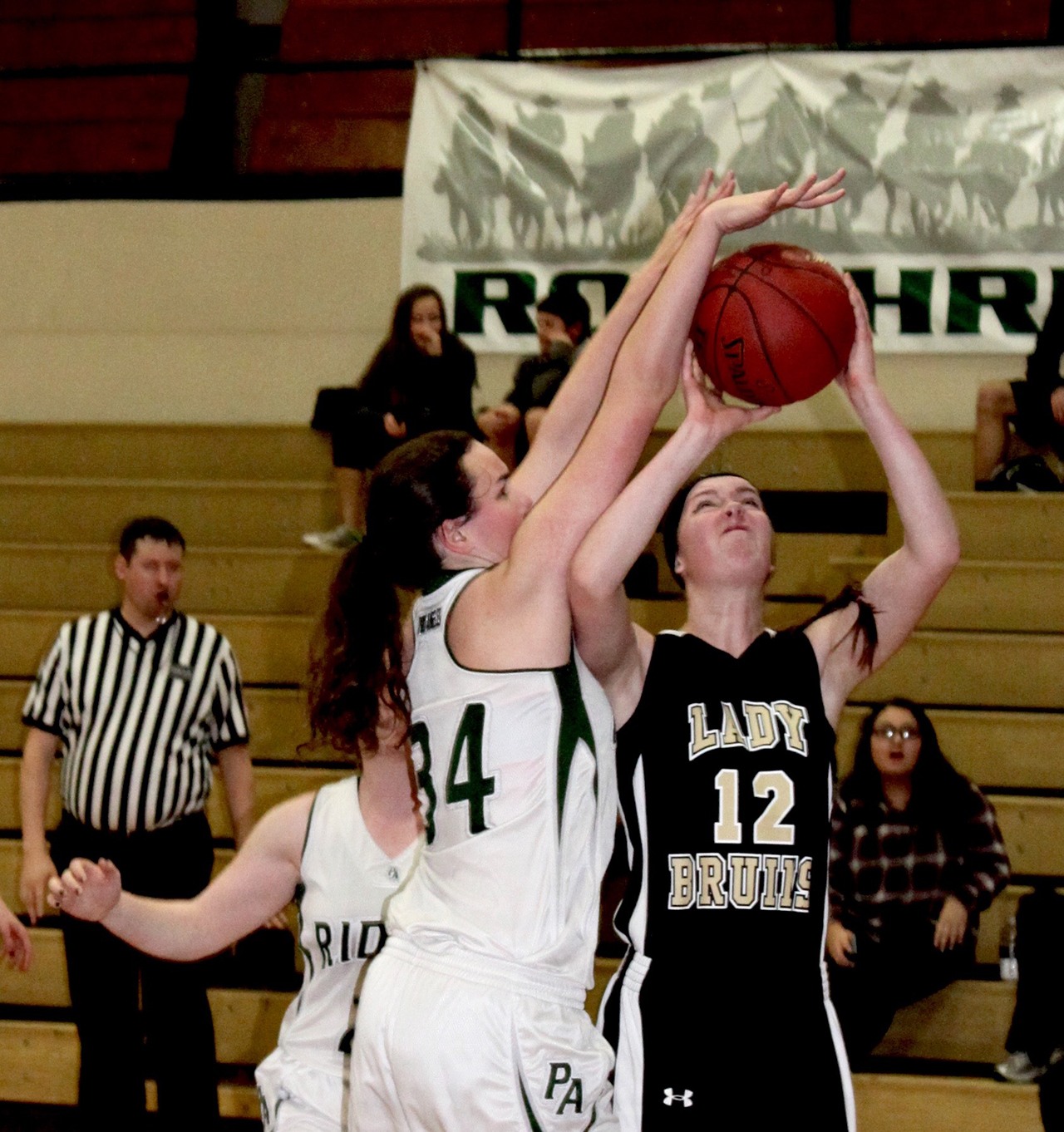 Clallam Bay&rsquo;s Molly McCoy, right, goes up for a shot against the defense of Port Angeles C Squad&rsquo;s Allison Locke. The Bruins topped the Roughriders 55-15 Wednesday at Port Angeles High School.