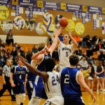Michael Dashiell/Olympic Peninsula News Group Sequim&rsquo;s Payton Glasser (5), rises to shoot above Chimacum&rsquo;s Lane Dotson during the Wolves season-opening win.