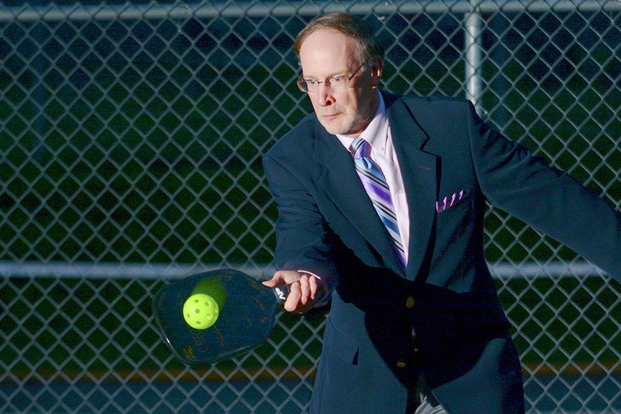 Dave Walter, chief operations officer at the Composite Recycling Technology Center in Port Angeles, demonstrates the CRTC&rsquo;s first product, a recycled aerospace-quality carbon fiber pickleball paddle. The paddle is the first product in the world made of recycled aerospace carbon fiber. (Jesse Major/Peninsula Daily News)