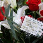 Flowers and a message from the Washington State Patrol Investigative Assistance Division are shown at a growing memorial outside the Tacoma Police Department headquarters Thursday in Tacoma. (Ted S. Warren/The Associated Press)