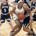 Keith Thorpe/Peninsula Daily News                                Peninsula&rsquo;s Jenise McKnight drives to the lane surrounded by Wenatchee defenders during Friday night&rsquo;s first round of the First Federal Pirate Classic in Port Angeles.