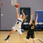 Steve Mullensky/for Peninsula Daily News Chimacum&rsquo;s Mechelle Nisbet goes up for a basket against Forks defender Ryan Peters, during a game in Chimacum on Friday.