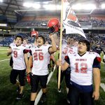 The Associated Press                                Neah Bay&rsquo;s Philip Greene (12) holds a Makah Indian Nation flag as he celebrates with teammates after Neah Bay beat Odessa-Harrington 64-34 to win the Washington Div. 1B high school football championship Saturday at the Tacoma Dome.