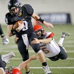 The Associated Press                                Odessa-Harrington quarterback Colton Hunt is tackled by Neah Bay linebacker Alan Tyler (5) during the second half of the Washington Div. 1B high school football championship Saturday at the Tacoma Dome.