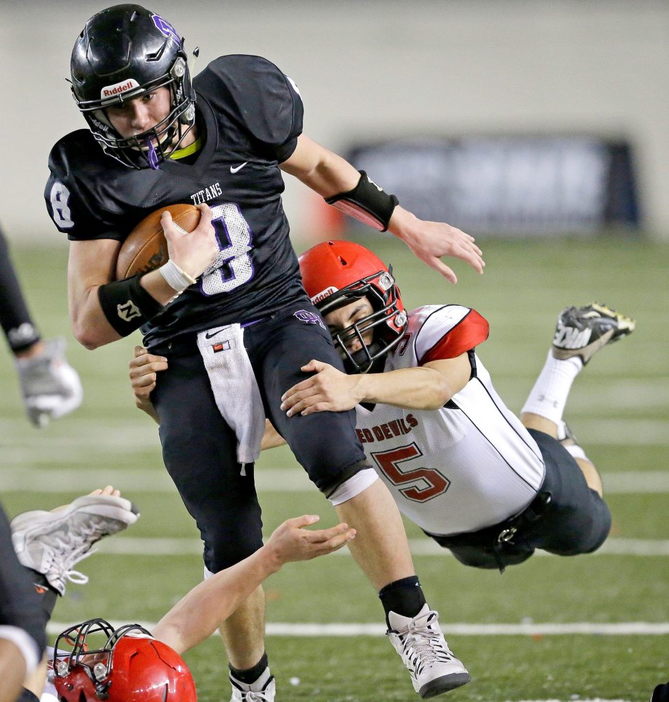 The Associated Press                                Odessa-Harrington quarterback Colton Hunt is tackled by Neah Bay linebacker Alan Tyler (5) during the second half of the Washington Div. 1B high school football championship Saturday at the Tacoma Dome.