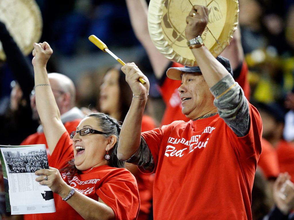 The Associated Press                                Neah Bay fans cheer and play a traditional drum during the first half of the Washington Div. 1B high school football championship against Odessa-Harrington Saturday at the Tacoma Dome.
