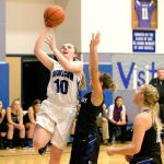 Steve Mullensky/for Peninsula Daily News Chimacum&rsquo;s Maddie Dowling, 10, goes up for a score, getting past the defense of North Mason&rsquo;s Hailey Simonson during the Cowboys&rsquo; 50-47 overtime win Monday in Chimacum.