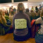 Protesters from Port Townsend and the surrounding areas participate in a silent sit-in at the Navy open house at Fort Worden on Monday. The group came to protest the Navy&rsquo;s plan to add new Growler aircraft to training on Whidbey Island, creating more noise for surrounding communities. (Cydney McFarland/Peninsula Daily News)