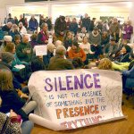 Protesters from Port Townsend and the surrounding areas participate in a silent sit-in at the Navy open house at Fort Worden on Monday. The group came to protest the Navy&rsquo;s plan to add new Growler aircraft to training on Whidbey Island, creating more noise for surrounding communities. (Cydney McFarland/Peninsula Daily News)