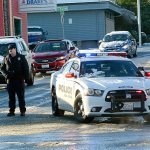 A Port Angeles police officer blocks Lincoln Street on Tuesday morning. Police blocked streets as cars slid and got stuck. (Jesse Major/Peninsula Daily News)