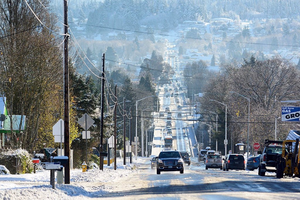 Traffic travels on the snow-covered Eighth Street in Port Angeles on Tuesday morning. (Jesse Major/Peninsula Daily News)