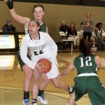 Dave Logan/for Peninsula Daily News Peninsula&rsquo;s Tiffani Smith (22), looks for help while surrounded by Highline defenders during the Pirates 73-52 win.