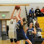 Lonnie Archibald/for Peninsula Daily News                                Forks&rsquo; Rian Peters (13) and Chimacum&rsquo;s Maddie Dowling (10) battle for a rebound during the Cowboys&rsquo; 53-37 win.