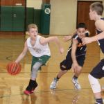 Dave Logan/for the Peninsula Daily News Port Angeles Park and Rec Dept held its annual Holiday Hoops tournament on Saturday and Sunday in the Port Angeles High School gym and at Stevens Gym. More than 40 teams participated with girls and boys from fourth through eighth grades playing. Dru Clark of the Port Angeles eighth-grade boys&rsquo; team looks to drive around defenders from the Drive, a team from Poulsbo.