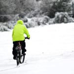A man rides his bike through the snow near the Clallam County Fair Grounds in Port Angeles on Monday morning. (Jesse Major/Peninsula Daily News)