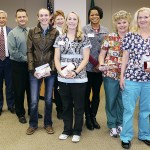 In front row, from left, are Olympic Medical Center employees Beverly Buck, CNA; Stacia Kiesser, RN; Julie Millsap, RN; and Cynthia Beltrami, RN. In back row from left are CEO Eric Lewis; Board President John Nutter; Lorraine Wall, RN, chief nursing officer; and Robin Burse, RN.