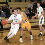 Dave Logan/for the Peninsula Daily News                                Port Angeles&rsquo; Noah McGoff, left, drives to the hoop while Bremerton&rsquo;s Diontae Madison goes for the steal during the Roughriders&rsquo; 53-44 win over the Knights.