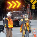 State Department of Transportation technician Paul Brown, right, uses a theodolite transit as coworkers Matt Winkelman, left, and Guy Wehr look on as crews survey the eastern approach to the Elwha River bridge west of Port Angeles on Wednesday. (Keith Thorpe/Peninsula Daily News)