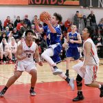 Steve Mullensky/for Peninsula Daily News Chimacum&rsquo;s Issac Purser goes up for a score as Port Townsend Redhawks Detrius Kelsall, 10, and Jacob Boucher watch during a game on Tuesday in Port Townsend.