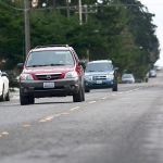Traffic travels on West 10th Street on Wednesday, a street that Port Angeles council members identified as needing repairs. (Jesse Major/Peninsula Daily News)