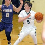 Keith Thorpe/Peninsula Daily News Port Angeles&rsquo; Noah McGoff, right, looks to pass around North Kitsap&rsquo;s Zach Olmstead during the Roughriders&rsquo; 59-56 loss to the Vikings.