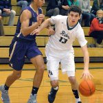 Keith Thorpe/Peninsula Daily News Port Angeles&rsquo; Luke Angevine, right, drives past North Kitsap&rsquo;s Kainen Warren during the Roughriders&rsquo; 59-56 loss to the Vikings. Angevine led Port Angeles with 20 points.