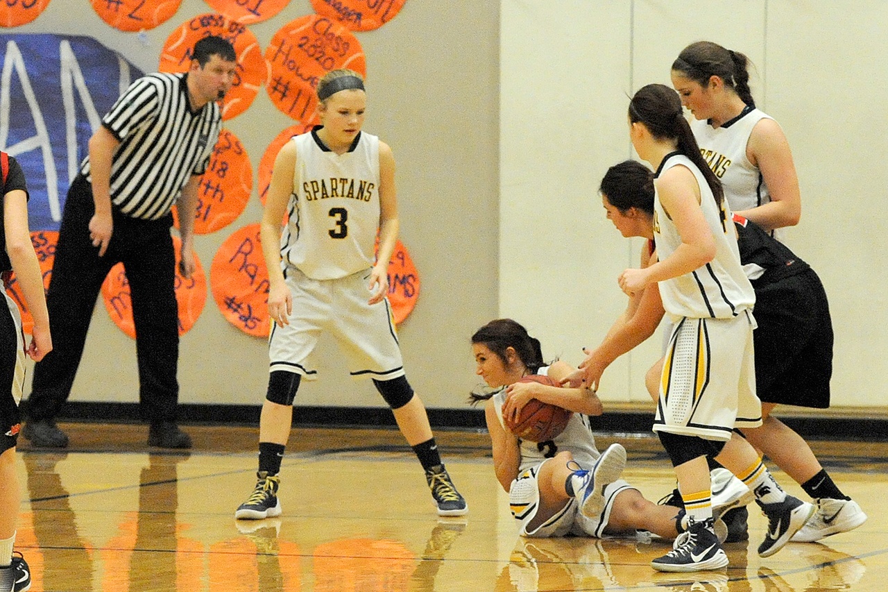 Lonnie Archibald/for Peninsula Daily News Forks&rsquo; Kaitlin Rowley keeps the ball away from the hands of Neah Bay&rsquo;s Kayla Winck. Looking on for Forks are, from left, Jayden Olso, Skyler DeMatties and Rian Peters.