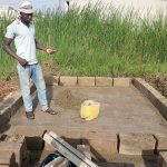 An unidentified man works on a compost toilet for a family living in the village of Zogbedgi, Togo, as part of the Dignity Toilets for Togo program. (Bedi Taouvik Boukari)