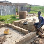 An unidentified man takes a break while working on a compost toilet for a family living in the village of Zogbedgi, Togo. Eight compost toilets have been built in the past two years, with plans to build 10 more. (Bedi Taouvik Boukari)