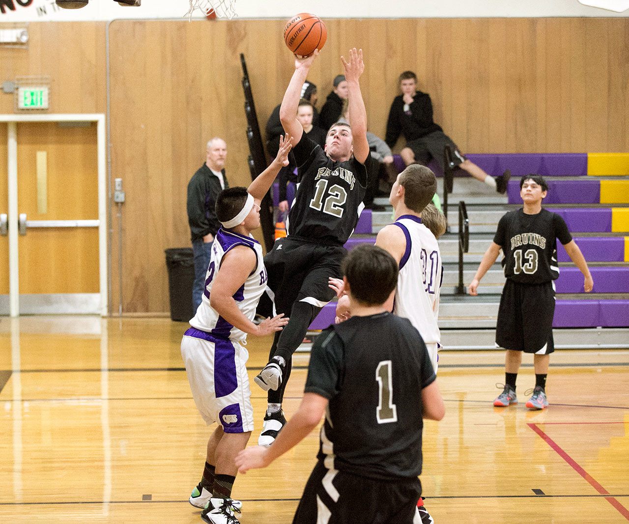 Steve Mullensky/for Peninsula Daily News                                Clallam Bay&rsquo;s Ryan McCoy, 12, goes up of a basket during a game played against the Quilcene Rangers on Monday in Quilcene.
