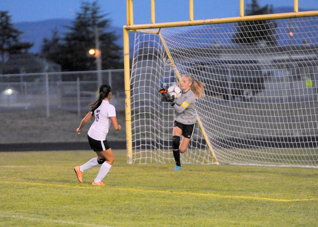 Matthew Nash/Olympic Peninsula News Group Sequim&rsquo;s Claire Henninger (with ball) makes a save during an early-season contest.