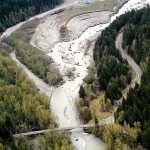 U.S. Highway 101 is shown crossing the Elwha River near the remains of the former Lake Aldwell in this April 2012 file aerial photograph. With the removal of the Glines Canyon Dam upstream of the bridge and the Elwha Dam downstream, the river has scoured its bed around pilings that support the bridge, prompting highway officials to consider plans to replace the structure. (Keith Thorpe/Peninsula Daily News)