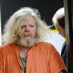 Andrew Helman, 58, accused of setting fire to his own home, is escorted into Clallam County Superior Court on Wednesday. (Jesse Major/Peninsula Daily News)​