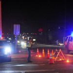 A state trooper directs traffic around a roadblock near Skagit Valley College in Mount Vernon on Thursday. (Brandy Shreve/Skagit Valley Herald via AP)