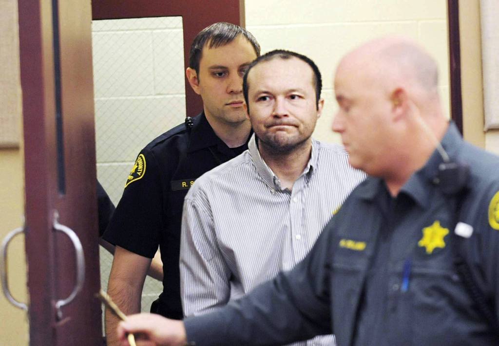 Ernesto Lee Rivas, center, is led into Skagit County District Court by Skagit County sheriff&rsquo;s deputies for his first court appearance in Mount Vernon on Friday. (Brandy Shreve/Skagit Valley Herald via AP)