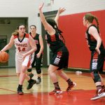 Steve Mullensky/for Peninsula Daily News Jenna Carson with the Redhawks stares down her Coupeville opponents as she gets set to drive for the basket during Olympic League action in Port Townsend on Tuesday.