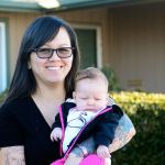Sarah Hayward of Port Angeles holds her 2-month-old daughter, Penelope Hayward, days after she says a man saved her family from certain death on New Year&rsquo;s Day. (Jesse Major / Peninsula Daily News)