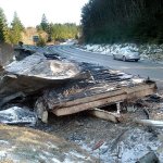 The charred remains of a modular home sit at the side of state Highway 112 at West Lyre River Road west of Joyce on Thursday. (Keith Thorpe/Peninsula Daily News)