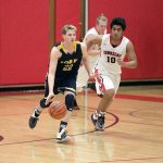 Steve Mullensky/for Peninsula Daily News Forks&rsquo; Parker Browning, 22, races Redhawk Detrius Kelsall down court during a Thursday night game in Port Townsend.