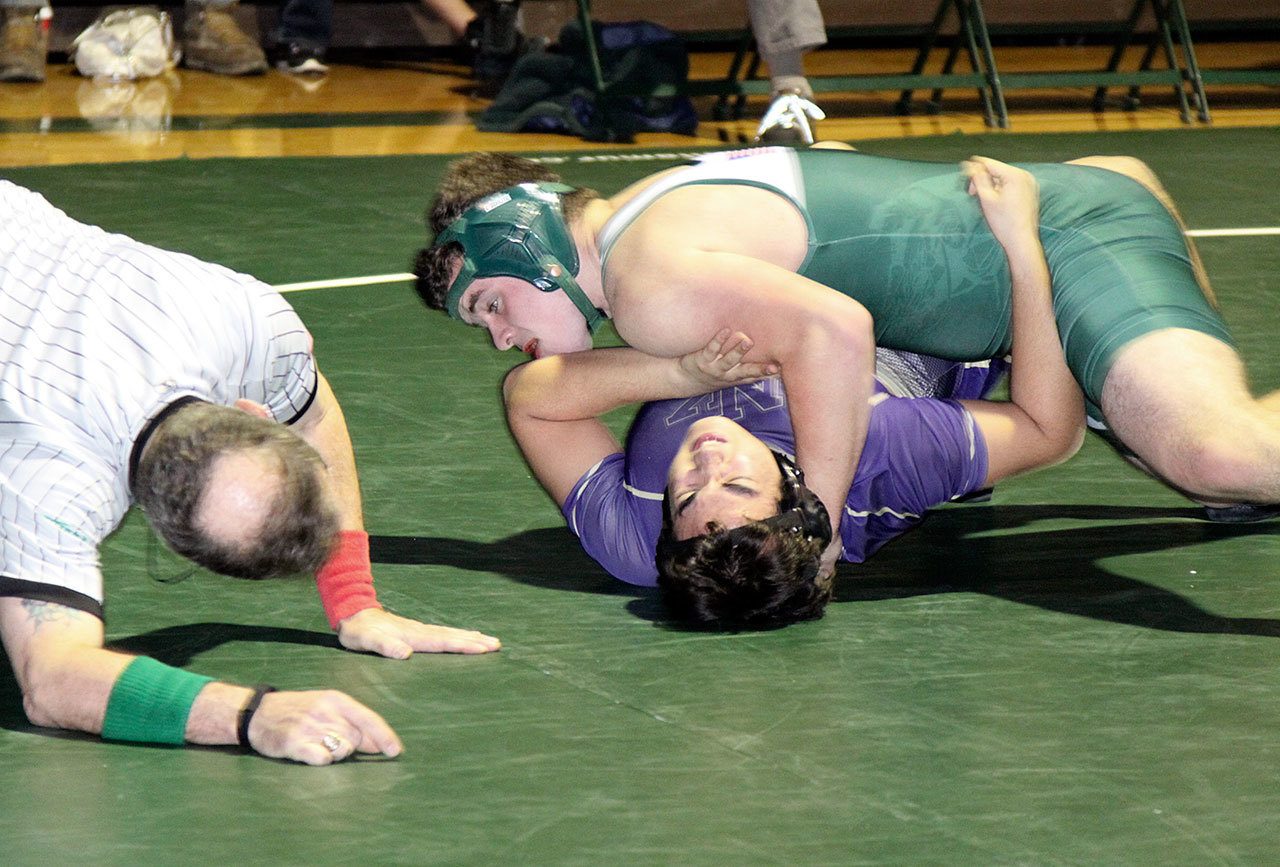 Dave Logan/for the Peninsula Daily News                                Port Angeles&rsquo; 220-pound Mason Coppage has position on his North Kitsap opponent Josh Snider. Coppage won by a pin.