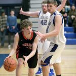 Steve Mullensky/for Peninsula Daily News Port Townsend&rsquo;s Jaden Watkins dribbles around Chimacum&rsquo;s Lane Dotson, 42, and Devyn Winkley, during Olympic League action in Chimacum on Tuesday.