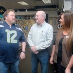 Peninsula Daily News General Manager Steve Perry, center, talks with Jim&rsquo;s Pharmacy owner Joe Cammack, left, and Chief Operations Officer Lisa Jorgensen after Perry received a check for $519.32 to the Peninsula Home Fund on Friday at the Port Angeles pharmacy. (Keith Thorpe/Peninsula Daily News)