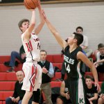 Steve Mullensky/for Peninsula Daily News                                Port Townsend&rsquo;s Berkley Hill hits a 3-pointer over the outstretched arm of Klahowya defender John Hartford during the Redhawks&rsquo; win over the Eagles.