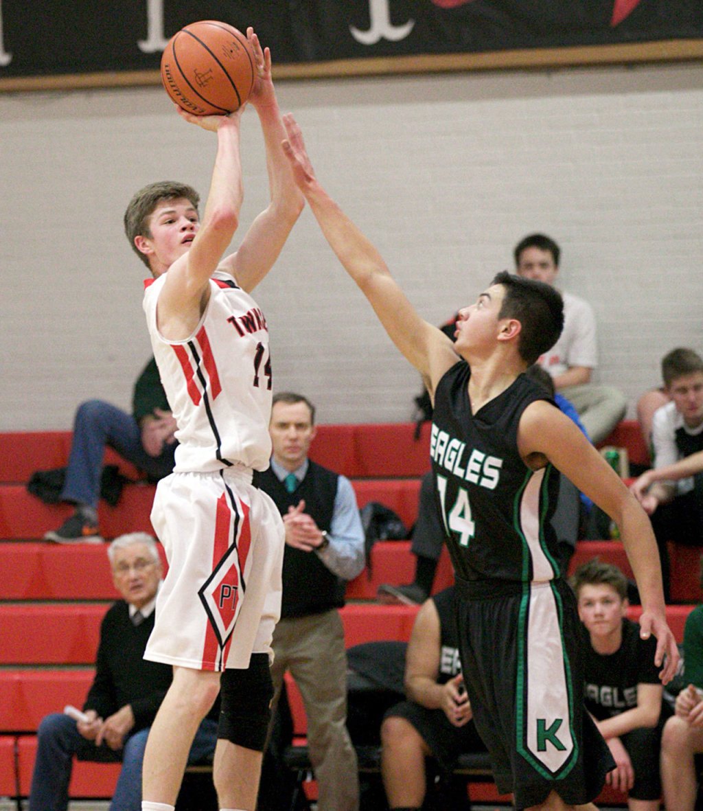 Steve Mullensky/for Peninsula Daily News                                Port Townsend&rsquo;s Berkley Hill hits a 3-pointer over the outstretched arm of Klahowya defender John Hartford during the Redhawks&rsquo; win over the Eagles.