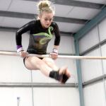 Dave Logan/for the Peninsula Daily News                                Port Angeles&rsquo; Laura Rooney competes on the uneven bars Monday in Port Angeles. The Roughriders won the meet against North Kitsap, Kingston and North Thurston.
