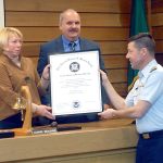 Port of Port Angeles Commissioners Connie Beauvais, left, and Steve Burke receive the Richard E. Bennis Award on Wednesday from U.S. Coast Guard Capt. Joe Raymond honoring the port for its effort to promote maritime transportation security. (Keith Thorpe/Peninsula Daily News)
