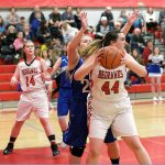 Steve Mullensky/for Peninsula Daily News Port Townsend&rsquo;s Izzy Hammett looks for someone to pass the ball to while being guarded by Chimacum&rsquo;s Shanya Nisbet during the Cowboys&rsquo; 42-28 win over the rival Redhawks.