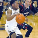 Keith Thorpe/Peninsula Daily News Peninsula&rsquo;s Darrion Daniels, left, slips around Olympic&rsquo;s JonRoss Juhas in first half play in Port Angeles on Wednesday night.