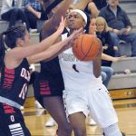 Keith Thorpe/Peninsula Daily News Peninsula&rsquo;s Anaya Rodisha, right, drives to the lane past the defense of Olympic&rsquo;s Libby Borogonia, left. and Zyriana Davies in the foruth quarter on Wednesday in Port Angeles.